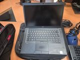 a laptop computer sitting on top of a bag on a desk