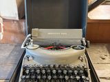 an old typewriter sitting in a case on the floor