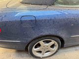a blue car that is parked on the side of the street