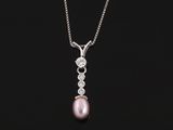 a pink pearl and diamond pendant on a silver chain