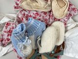 several pairs of baby shoes are laid out on a blanket