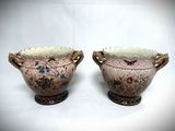 two vases that are sitting side by side on a white surface