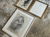 three framed pictures of a man sitting on a table