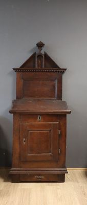 a wooden cabinet with a door on the top of it