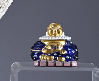 a figurine of a man sitting on top of a box
