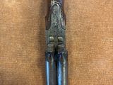 un vieux pistolet avec une poignée en bois sur une surface brune