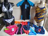 trois mannequins devant un présentoir de maillots de bain