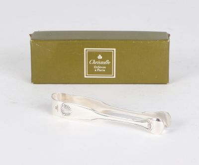a silver spoon and a box on a white surface