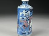 a small blue and white vase with a pink top