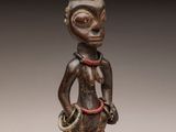 an image of a wooden statue of a man with a hat on his head