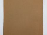 a piece of brown paper sitting on top of a white surface