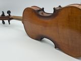 an old violin sitting on top of a white surface