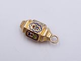an image of a gold and enamel charm with a flower design on it