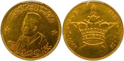 a close up of two gold coins with a crown on them