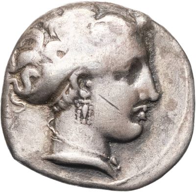 a silver coin with a woman ' s face on it