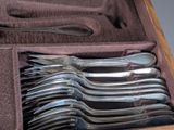 a lot of spoons and forks in a case