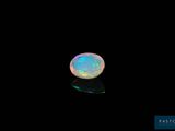 a white oplite in the dark with a black background