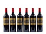 six bottles of red wine lined up on a white surface