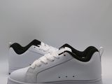the white and black sneakers are on a white surface