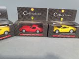 three toy cars are sitting in a box on a table