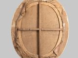 a round wooden window with a cross on it