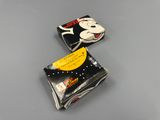 two black and white mickey mouse wallets sitting on top of a table
