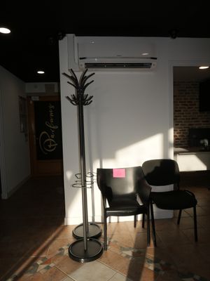 two chairs and a table in a room with a lamp