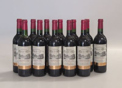 six bottles of wine lined up in a row on a table