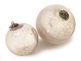 two white glass ornaments on a white surface