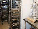 many trays of food that are on the shelves in the kitchen