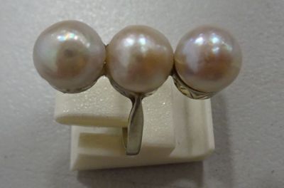 three white pearls are sitting on top of a white surface