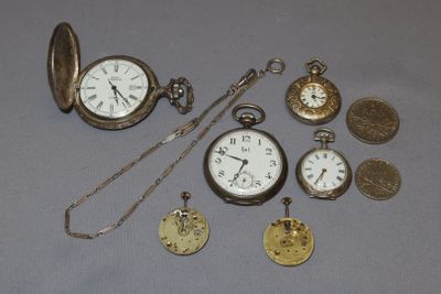 many different types of pocket watches on the table