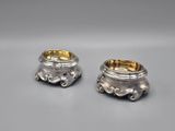 a pair of silverplated candlesticks on a table