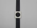 the apple watch is sitting on a white surface with a black band