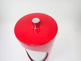 a red container with a white lid sitting on a table