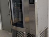 a large stainless steel oven in the middle of a room