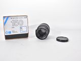 the camera lens is sitting next to the box of the camera