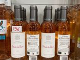 bottles of wine are lined up on a shelf in a store