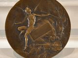 a bronze plate with a picture of a woman on it