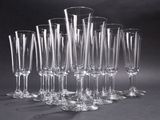 a lot of wine glasses that are lined up together