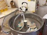 a large metal bowl with a mixer inside of it