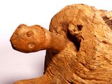 a sculpture of a turtle made of wood sitting on a table