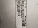 the back of a laptop computer with a bar code on it