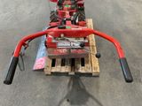 an image of a small red tractor on a pallet