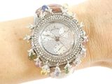 a woman ' s wrist that has a watch on it