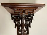 an old wooden shelf with a decorative design on top of it