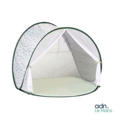 a white tent with a green trim on it