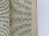 someone is holding a book open on a white surface