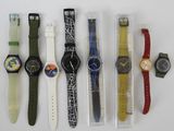 many different watches that are sitting in a row