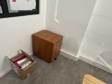 a box sitting in the corner of a room next to a window